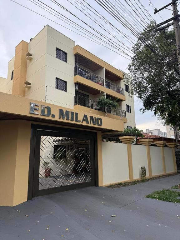 a building with a garage door in front of it at Meu cantinho in Dourados