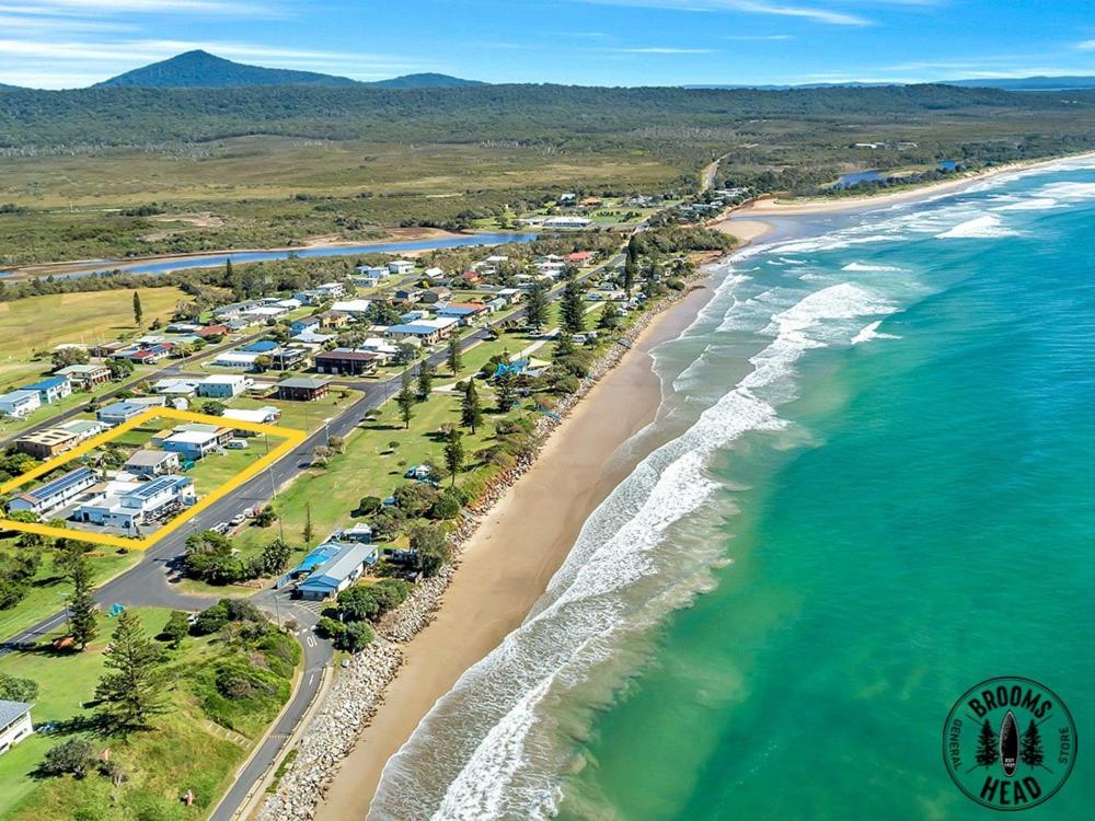 an aerial view of a beach with houses and the ocean at Beachside at Brooms in Brooms Head