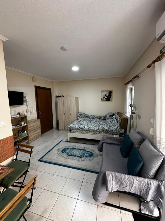 a living room with a bed and a couch at Studio Kastra in Thessaloniki