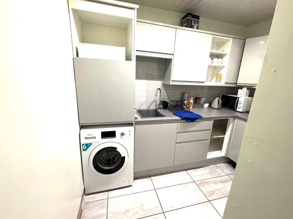 a kitchen with a washer and a washing machine at meze in Perth