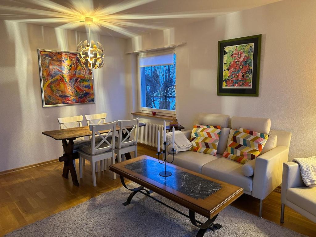 a living room with a couch and a table at TheCrown in Kilchberg