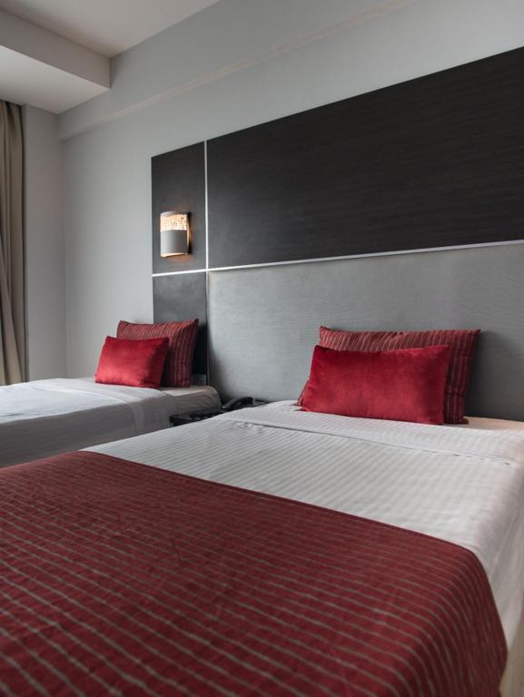 Postel nebo postele na pokoji v ubytování Cloud Hotel & Suites