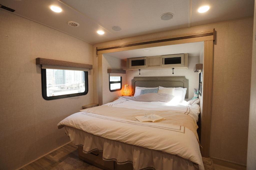 a bedroom with a large bed in a trailer at NamSan203 Guest house in Seoul