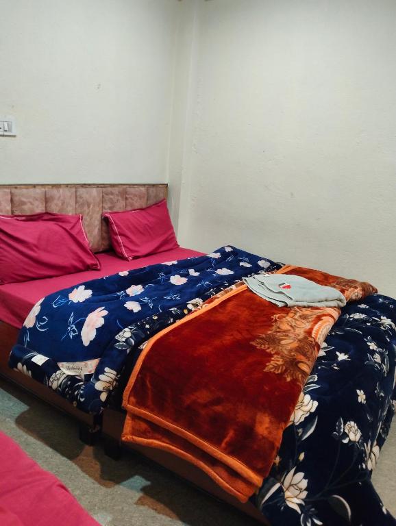 a bed with a blanket on it in a room at Hotel vivekanand in Badrinath