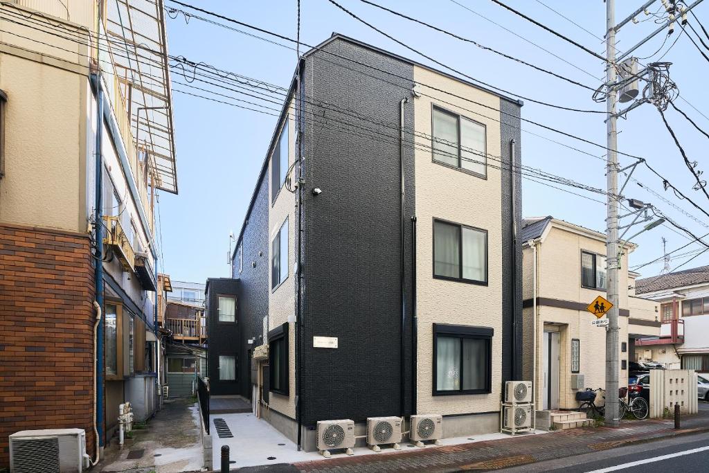 a black building on the side of a street at Reberty Haneda in Tokyo
