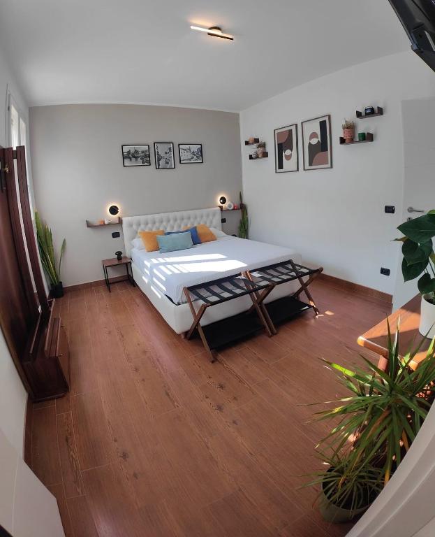 a bedroom with a bed and a wooden floor at Chez Nous in Comacchio