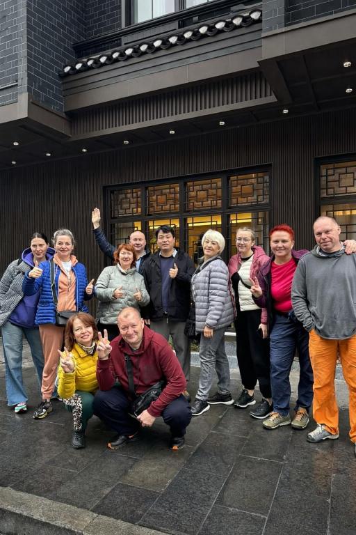 a group of people standing in front of a building at Phoenix Haven in Fenghuang County