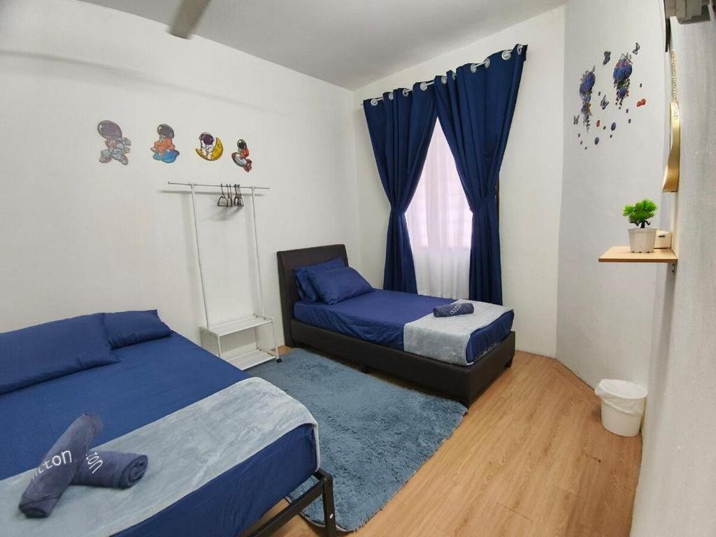 a bedroom with two beds and a window at 571 Seroja Homestay in Sungai Petani