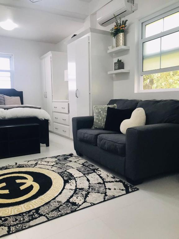 a living room with a couch and a rug at Casa Bonita GLAM in Castries