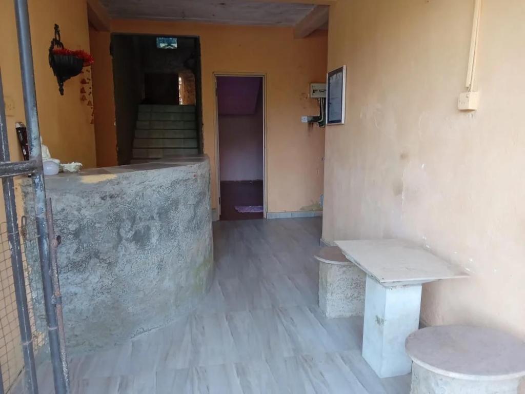 a hallway with a bench and stairs in a room at Hotel Silent River in Ingiriya
