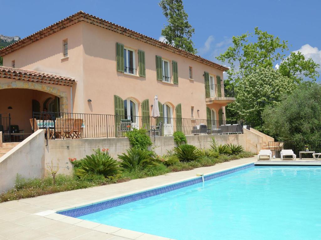 a house with a swimming pool in front of a house at Modern Villa with Private Pool in Cabris in Cabris