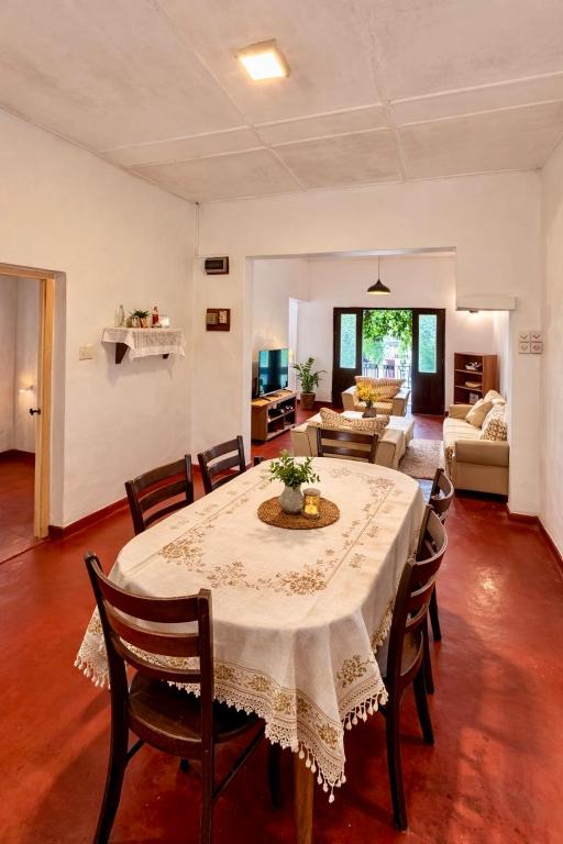 a living room with a table and chairs at Alex s Cottage in Kandy