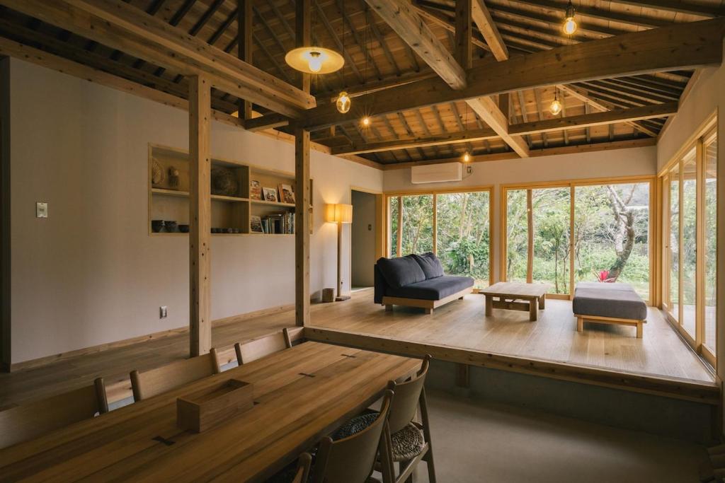 a living room with a couch and a table at 比地の宿 in Kunigami