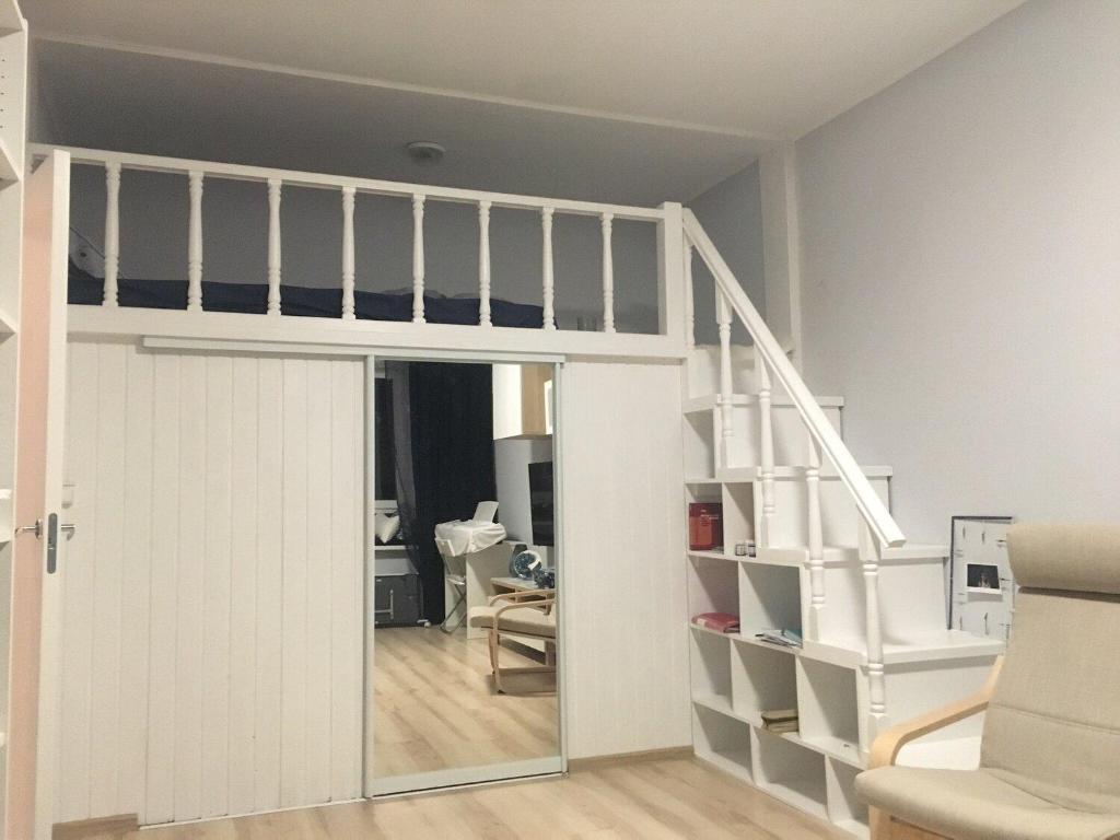 a room with a loft bed and a staircase at ANGSANA PREMIUM 2BR Apartment near BangTao Beach in Laguna Phuket