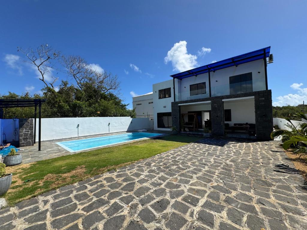 a house with a swimming pool in the backyard at Authentica Private Villa by Oceanaxe Holidays in Calodyne