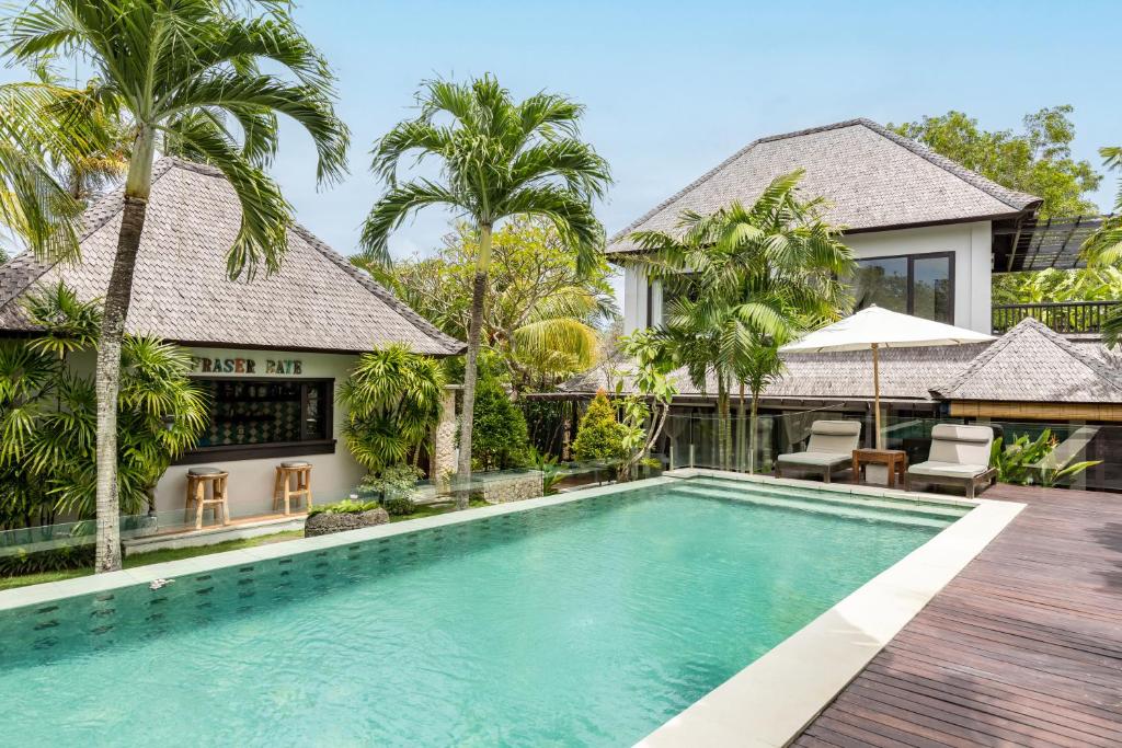 an image of a swimming pool in front of a villa at Fraser Baye Villas in Uluwatu