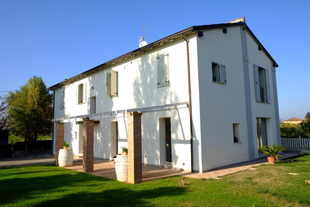 a white house with large windows at il leccio in San Lazzaro di Savena