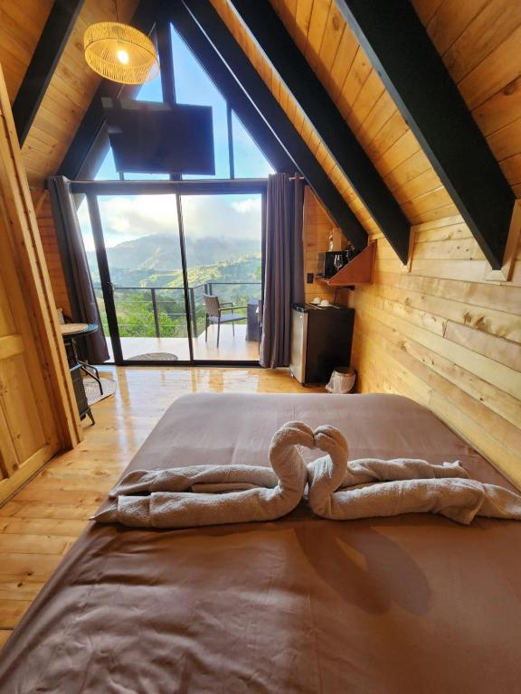 a large bed in a room with a large window at Brisas De Los Santos Lodge 1 in Sierra