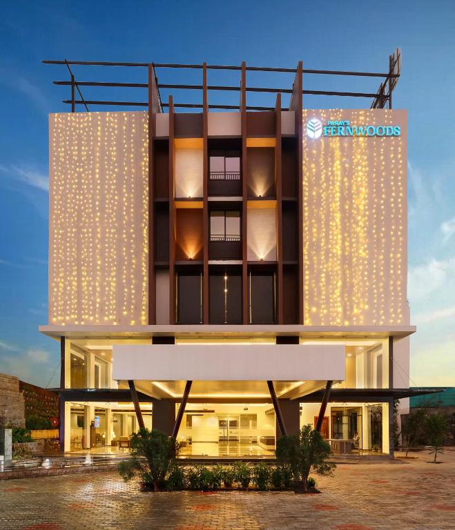 a building with a sign on the side of it at Parays Fernwoods in Mannārakkāt