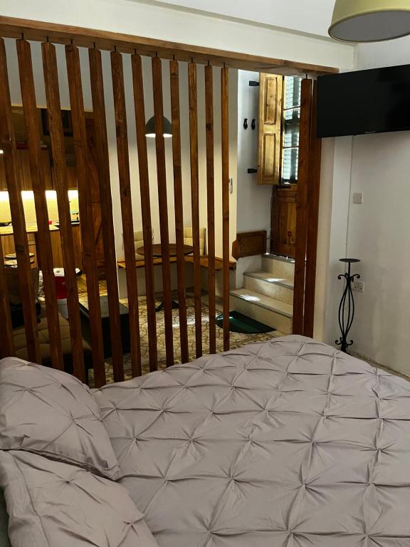a bedroom with a bed with a staircase in the background at Magdalena in Cospicua