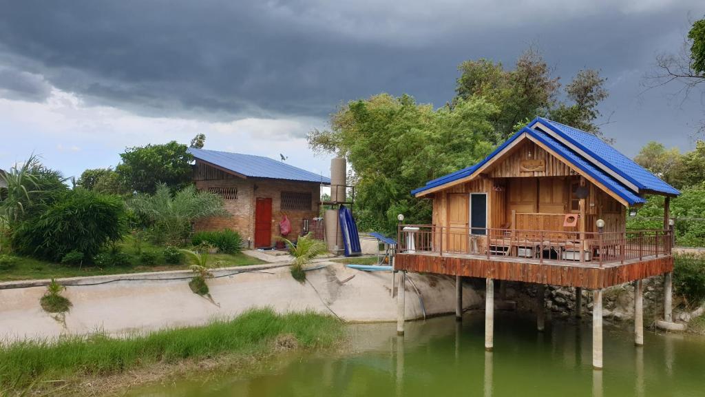 a house in the middle of a body of water at Min Land Resort in Ban Lan Nok