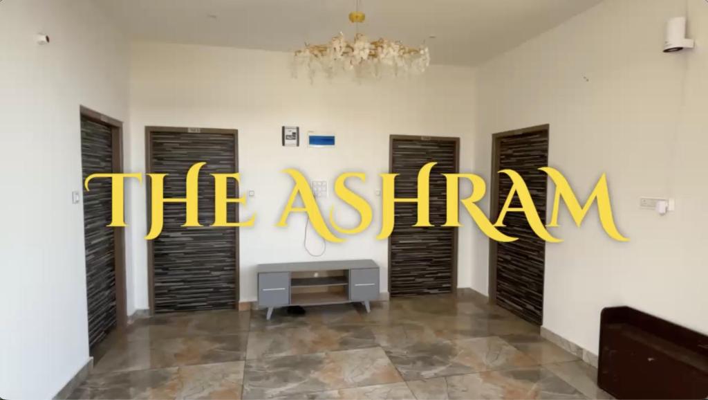 a room with black doors and a sign that reads the asern at Kinara by The Ashram in Bīr