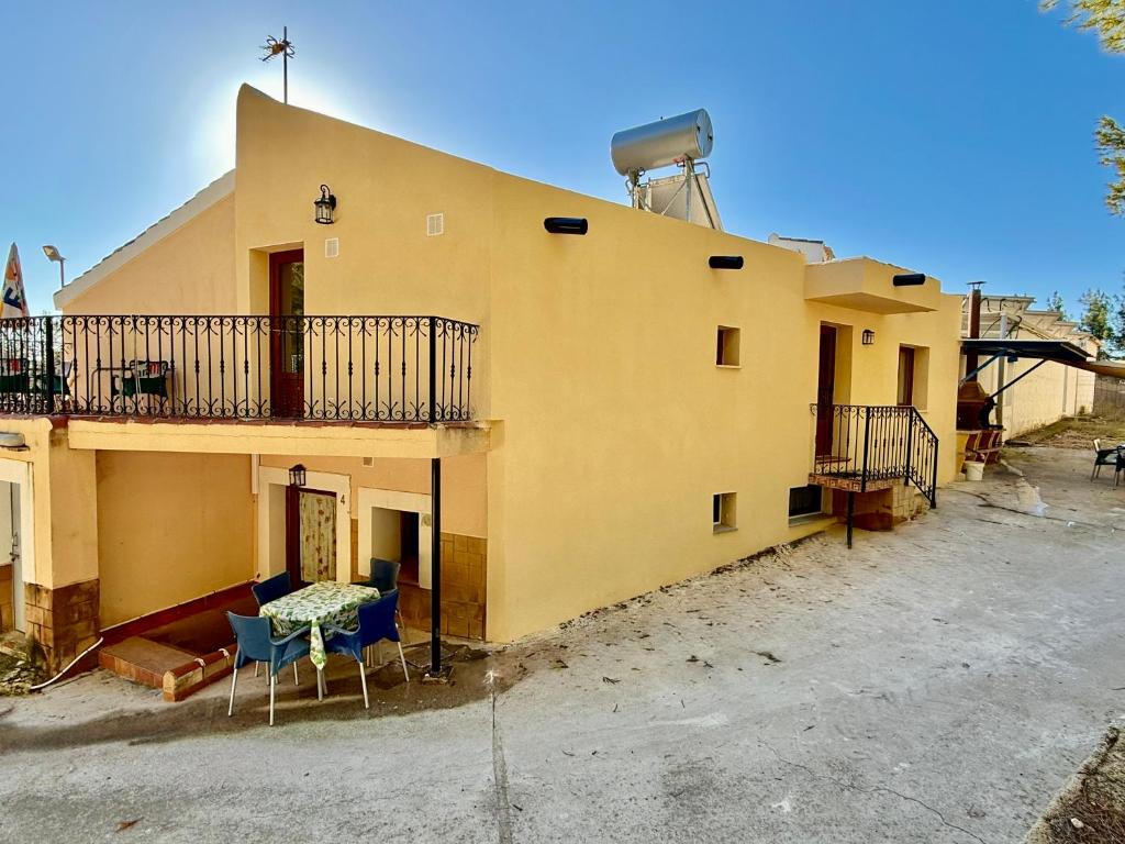 a yellow house with a table and chairs in front of it at RAPIA Casa Beig 5 in Moratalla