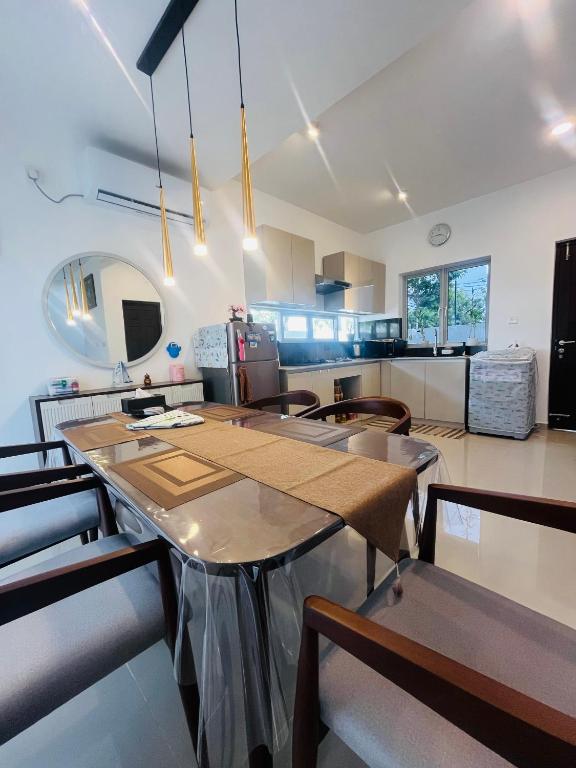 a kitchen and dining room with a table and chairs at The Galene Villa By Celestial Ceylon in Negombo