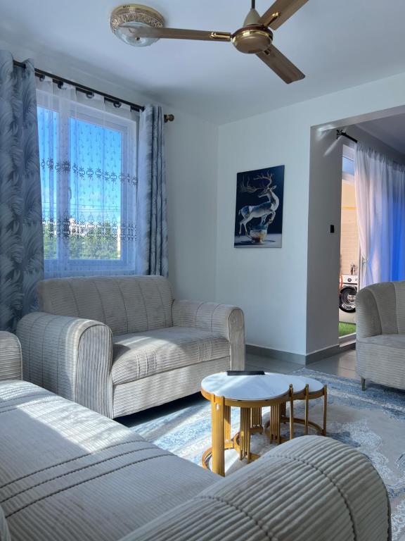 a living room with two couches and a table at Hidden gem-Nyali Vale Residence in Mombasa