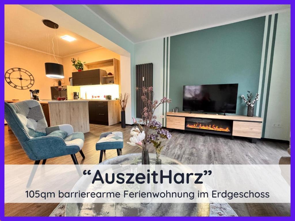 a living room with a tv and a fireplace at Ferienwohnung Auszeit Harz in Bad Sachsa