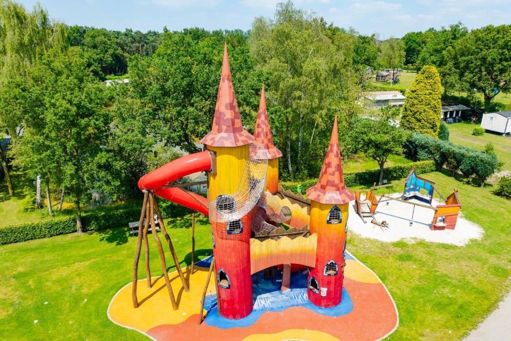 a playground with a slide in a park at Capfun Fort Bedmar in Sint-Gillis-Waas