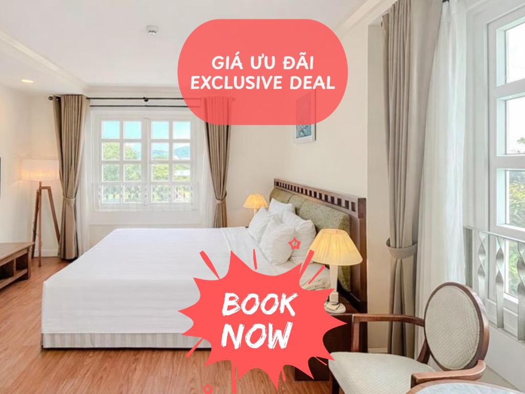 a bedroom with a bed with a book now sign on it at Phoenix Hotel Vung Tau in Vung Tau