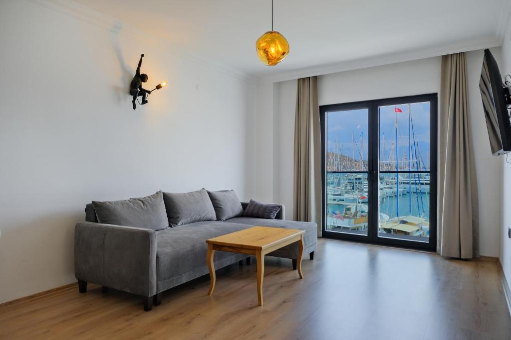 a living room with a couch and a table at Körfez Apart in Fethiye