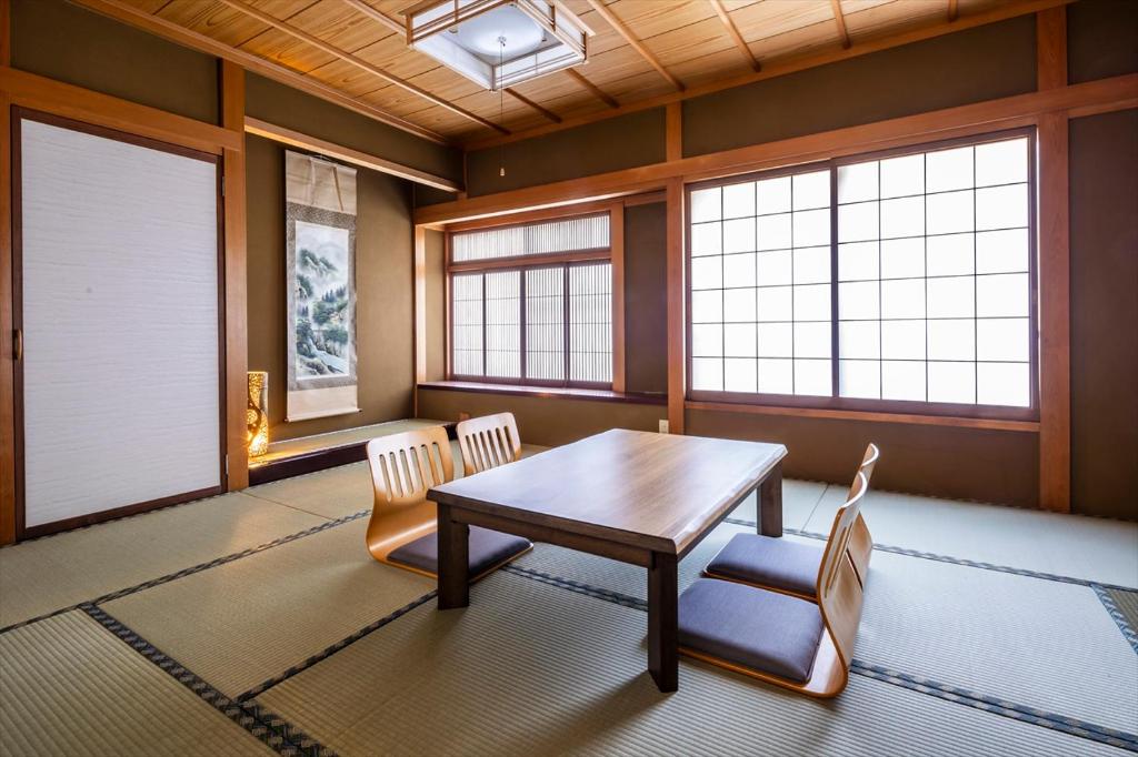 a dining room with a table and two chairs at live takayama-Stay with a Rescue Dog and Local Host in Takayama