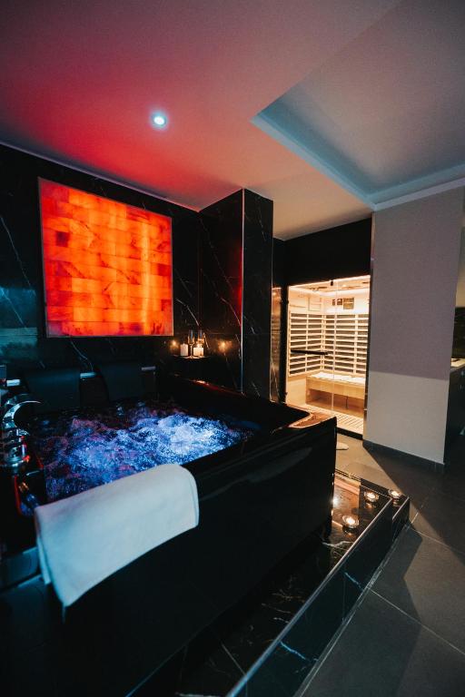 a living room with a bed and a fireplace at Artemide Suite Spa in Lido Di Fondi