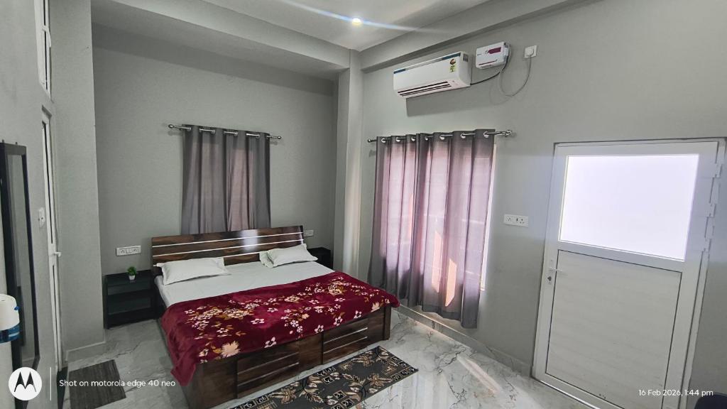 a bedroom with a bed and a window at Sree jee stay in Varanasi