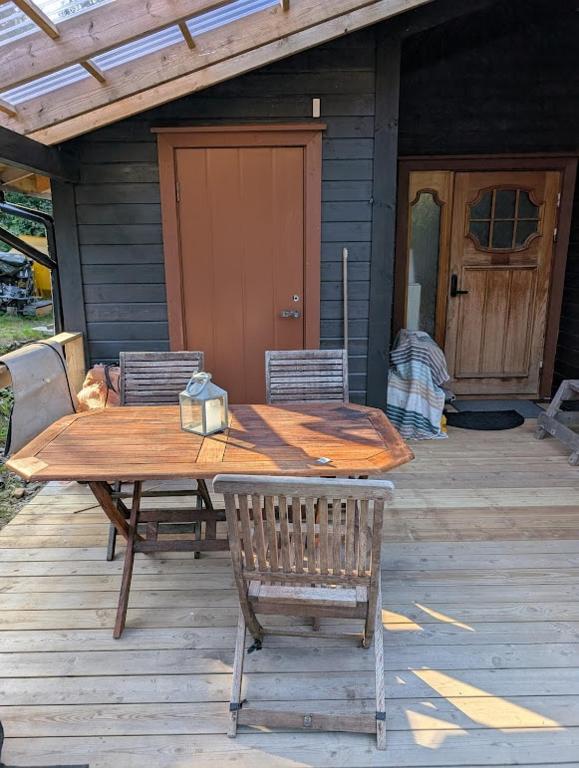 a wooden table and chairs on a patio at Rasteplassen in Stordalen