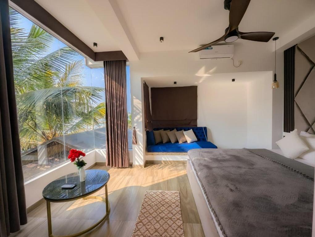 a living room with a bed and a glass table at White Tree Apartment in Bentota