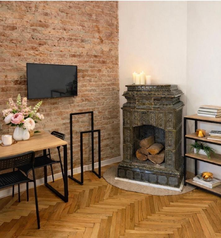 a living room with a brick wall and a fireplace at Gogol 14 Апартаменти в історичному центрі міста in Uzhhorod