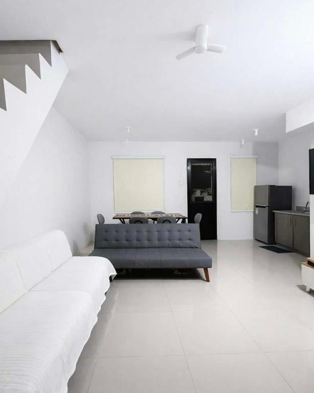 a living room with a couch and a table at Ben & Ben - Unit 2 in Cebu City