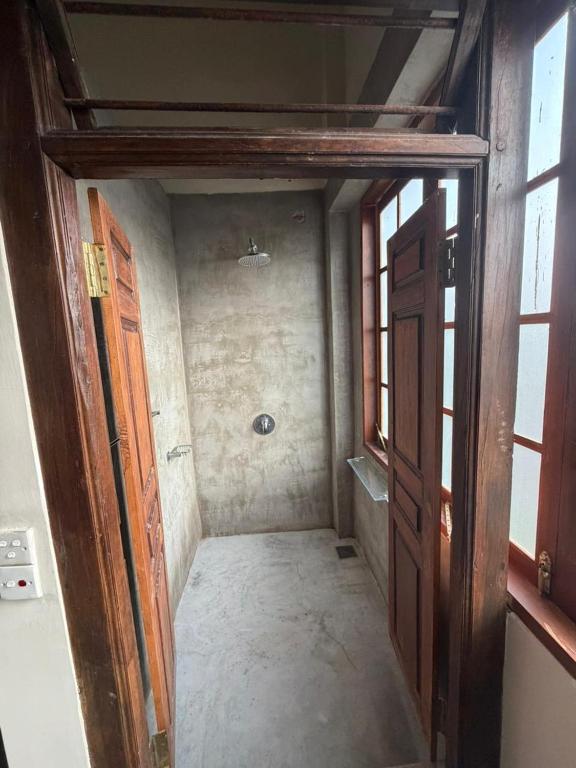 a hallway with an open door in a room at Weaver Bird Residencies in Hewagama