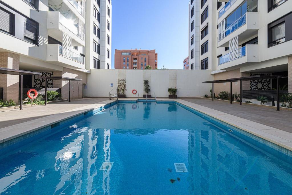 a swimming pool in the middle of a building at Maritimo Apartment in Malaga by Solaga Holiday Homes in Málaga