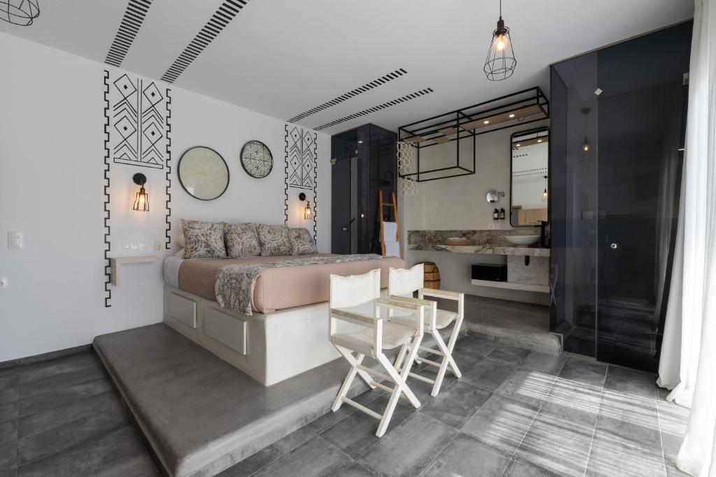 a bedroom with a bed and a table and chairs at K Studios in Faliraki