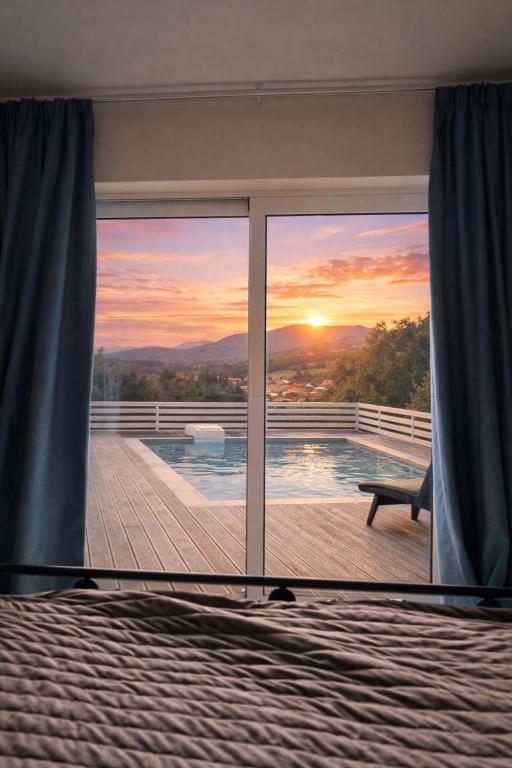 a room with a view of the sunset through a window at Casa Campanario Villa - Charming Nature Villa with Pool in a Picturesque Village By Villa Mana Gers in Agios Leon