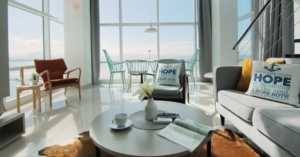 a living room with a couch and a table at Maritime Full Seaview Duplex Suites in George Town