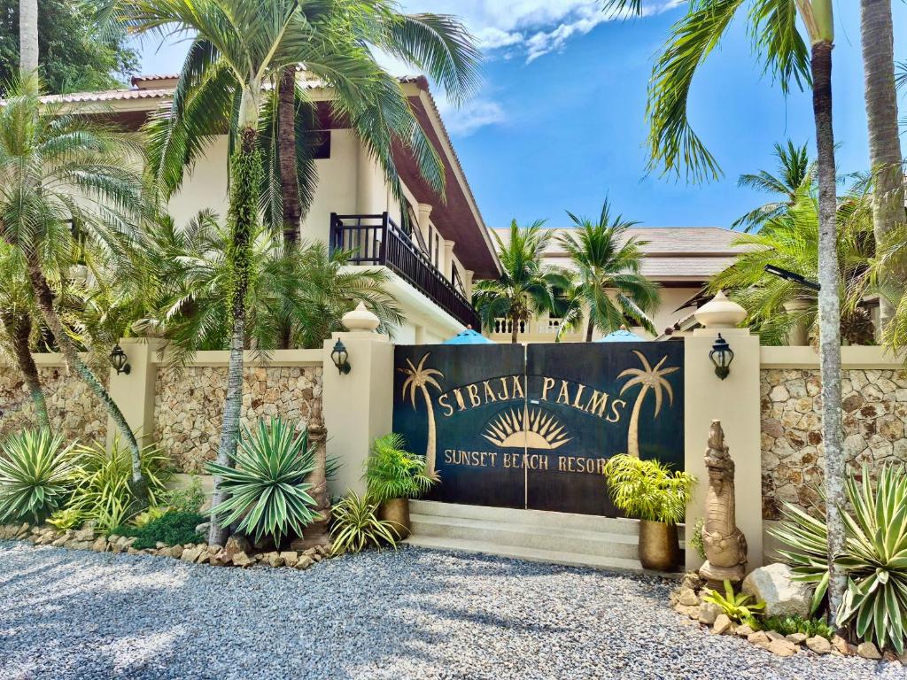 a sign in front of a building with palm trees at Sibaja Palms Sunset Beach Luxury Villa in Taling Ngam Beach