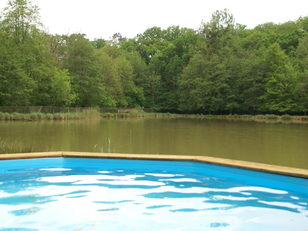 a swimming pool in front of a body of water at Luxurious Holiday Home in Delain with bubble bath in Delain