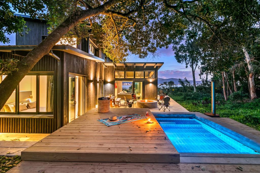 a house with a swimming pool on a wooden deck at Knysna Tsukamori in Knysna