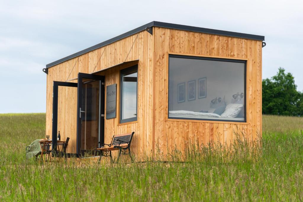 a tiny house in a field of tall grass at KOOLNA pod kopcem in Valašské Meziříčí