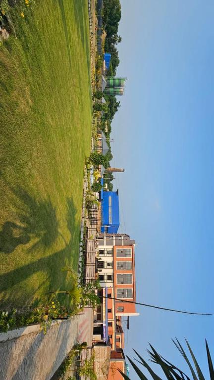 an aerial view of a building and a grassy hill at Balaji Hotel and Resturant in Kolaghat